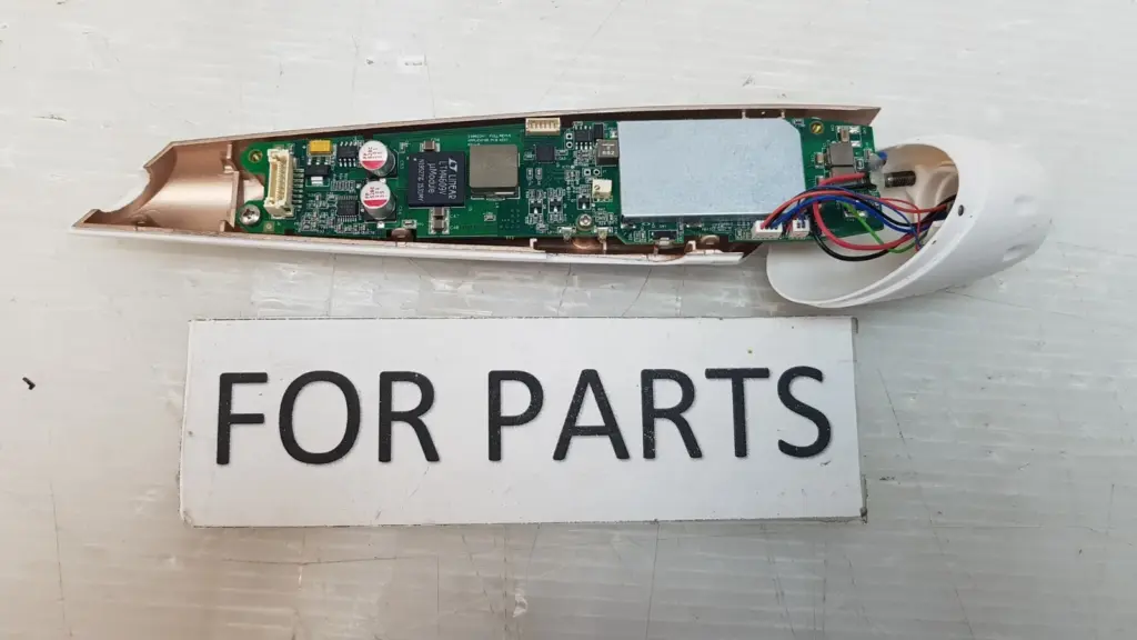 Opened applicator shell with PCB assembly 25002341 and a FOR PARTS sign