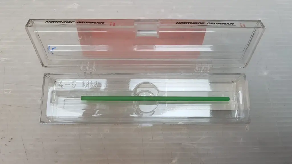 H0236E YAG laser rod, 4 × 130 mm, in a clear Northrop Grumman Synoptics case