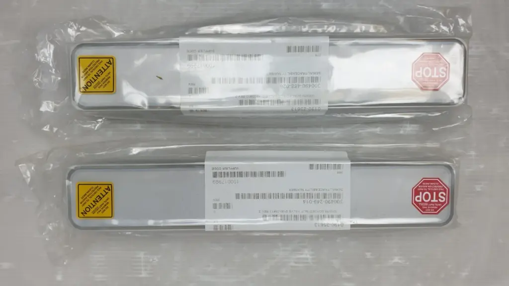 Two Applied Materials 0190-25613 300mm bonded slit valve parts in sealed bags with AMAT labels