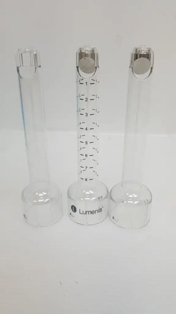 Three clear Lumenis handpiece tips standing on their cup-shaped bases