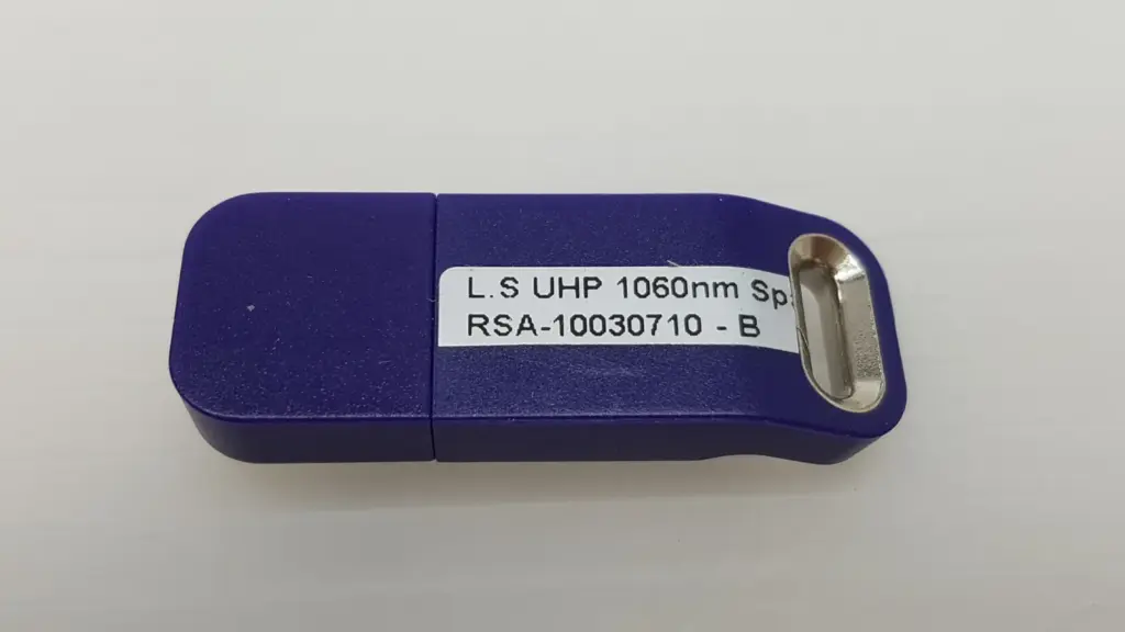 Lumenis RSA-10030710-B USB key labelled L.S UHP 1060nm, purple housing with cap