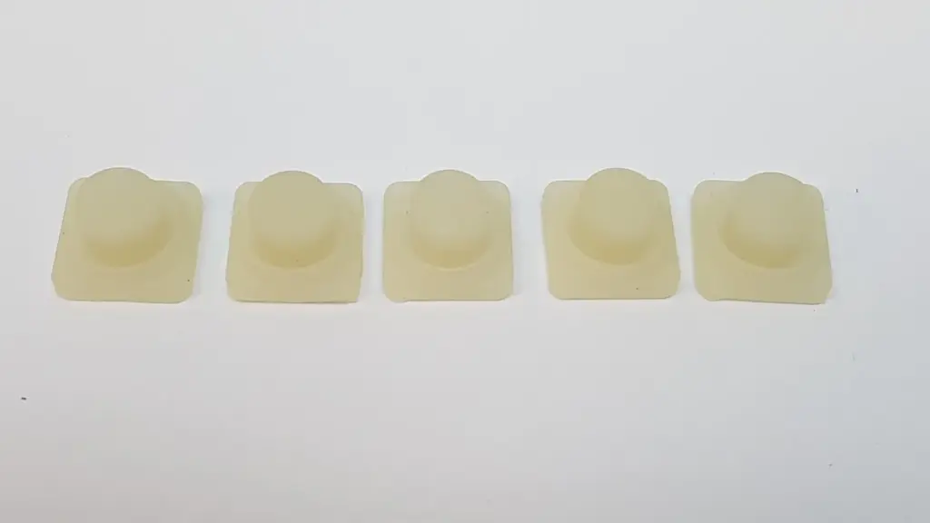 Five Lumenis MI-1140351 HS enable knobs, translucent off-white, top view