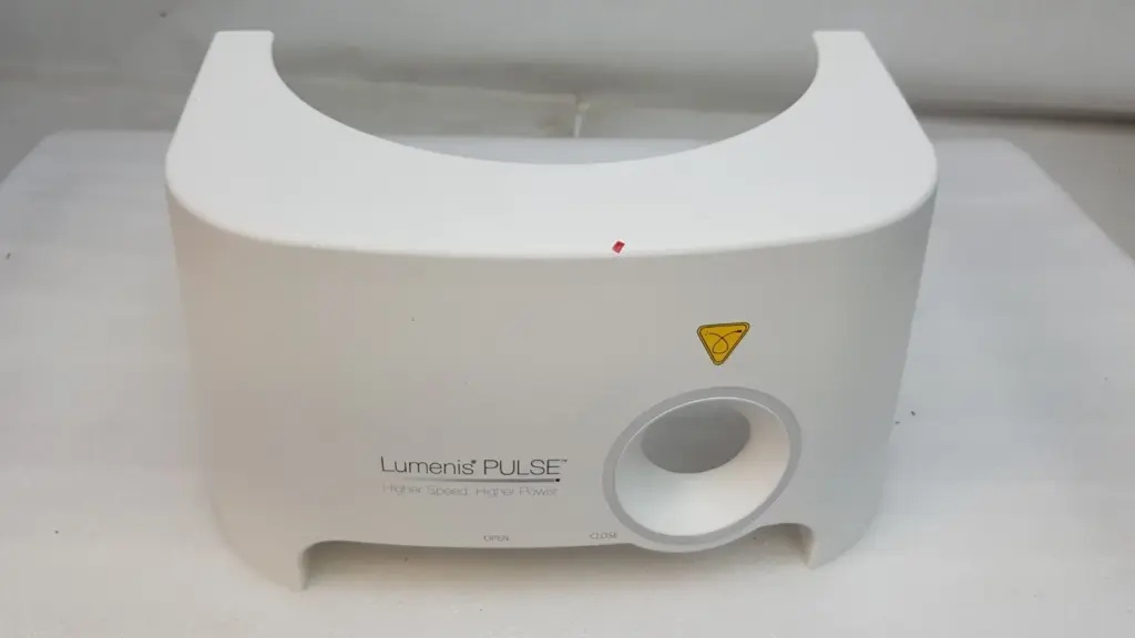 White Lumenis Pulse plastic cover with round port bezel and yellow laser warning label