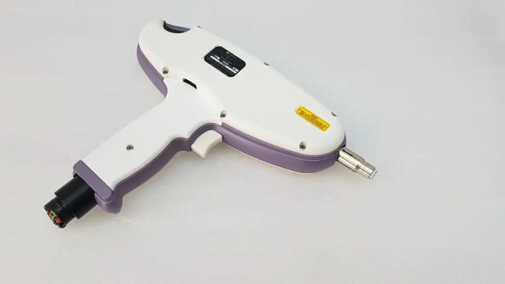 Lumenis Quantum gun-style handpiece, white and purple, with nameplate and metal front nozzle