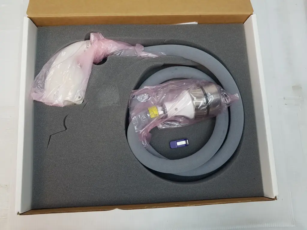 Lumenis SA-10030710 LightSheer handpiece and cable in bags in a foam-lined box with a USB key