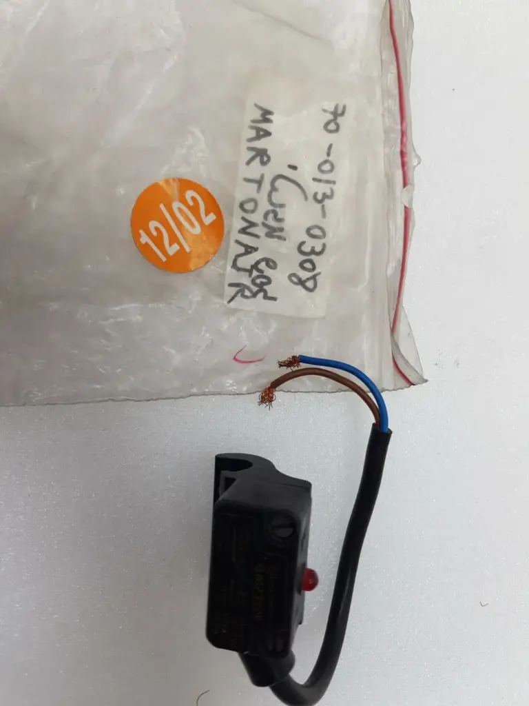 Martonair QM/32/5 reed switch with brown and blue leads beside its storage bag