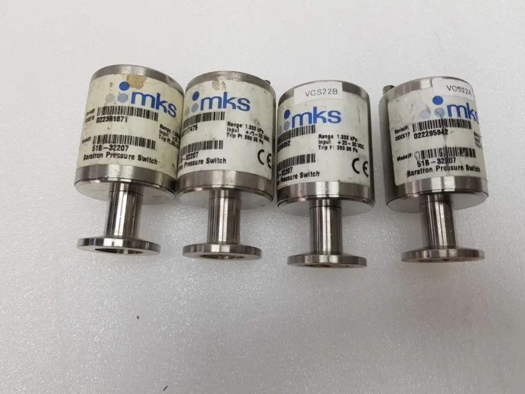 Four MKS 51B-32207 Baratron pressure switches standing on their vacuum fittings