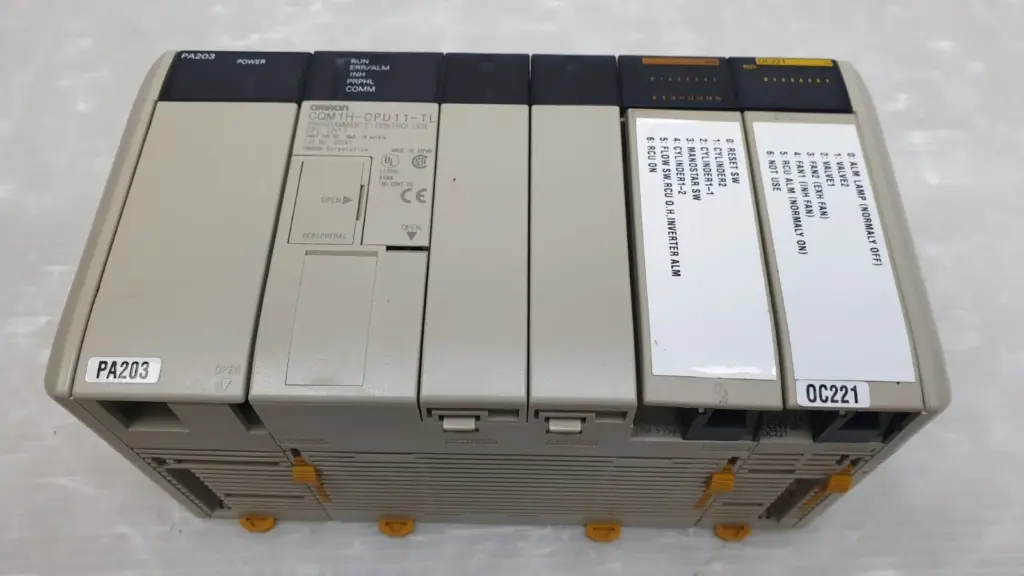 Omron CQM1H PLC assembly: PA203 power supply, CQM1H-CPU11-TL CPU unit and OC221 relay output unit
