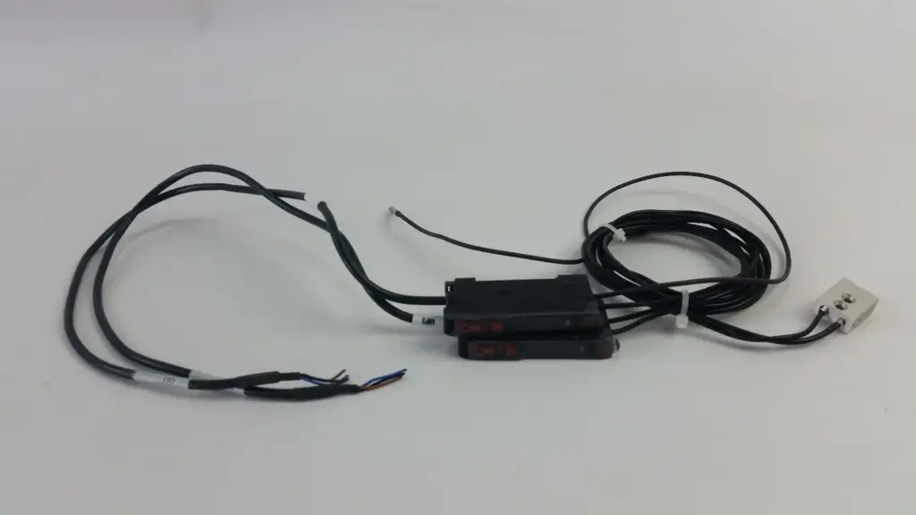 Two Omron E3X-DA11-N digital fiber amplifiers with power cables and fiber-optic cables