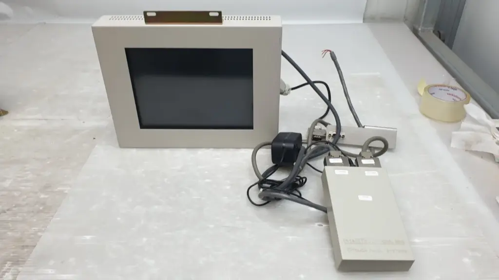 Tokyo Electronic Industry TE6036A7 touch screen monitor with cables and a grey interface box