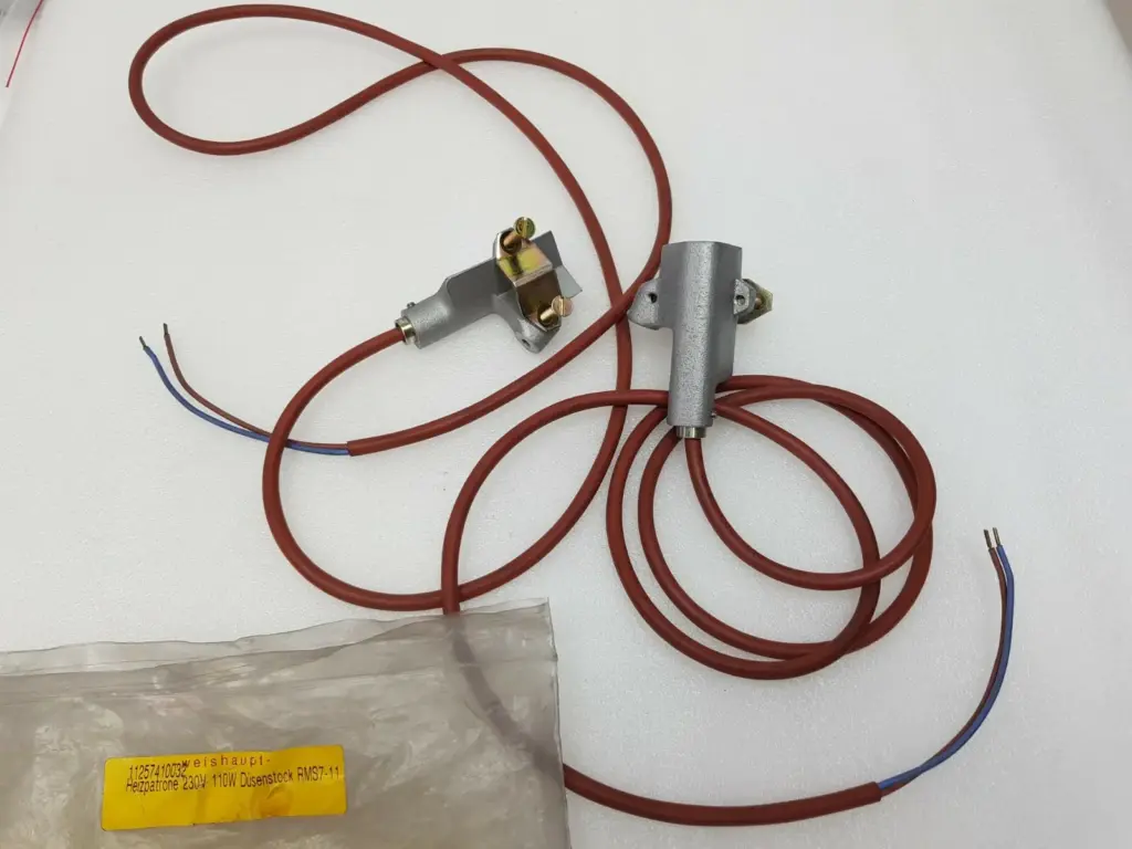 Two Weishaupt 11257410032 heating cartridges with red leads and metal holders, beside the labelled bag