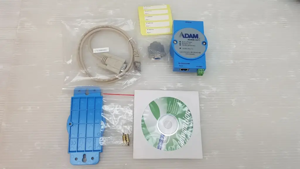 Advantech ADAM-4571 gateway set: module, serial cable, DB9 adapter, IP labels, blue mounting plate, standoffs and driver CD