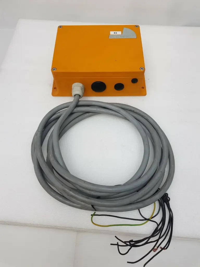 Hetronic RX 10/K radio remote control receiver, orange housing with coiled grey control cable