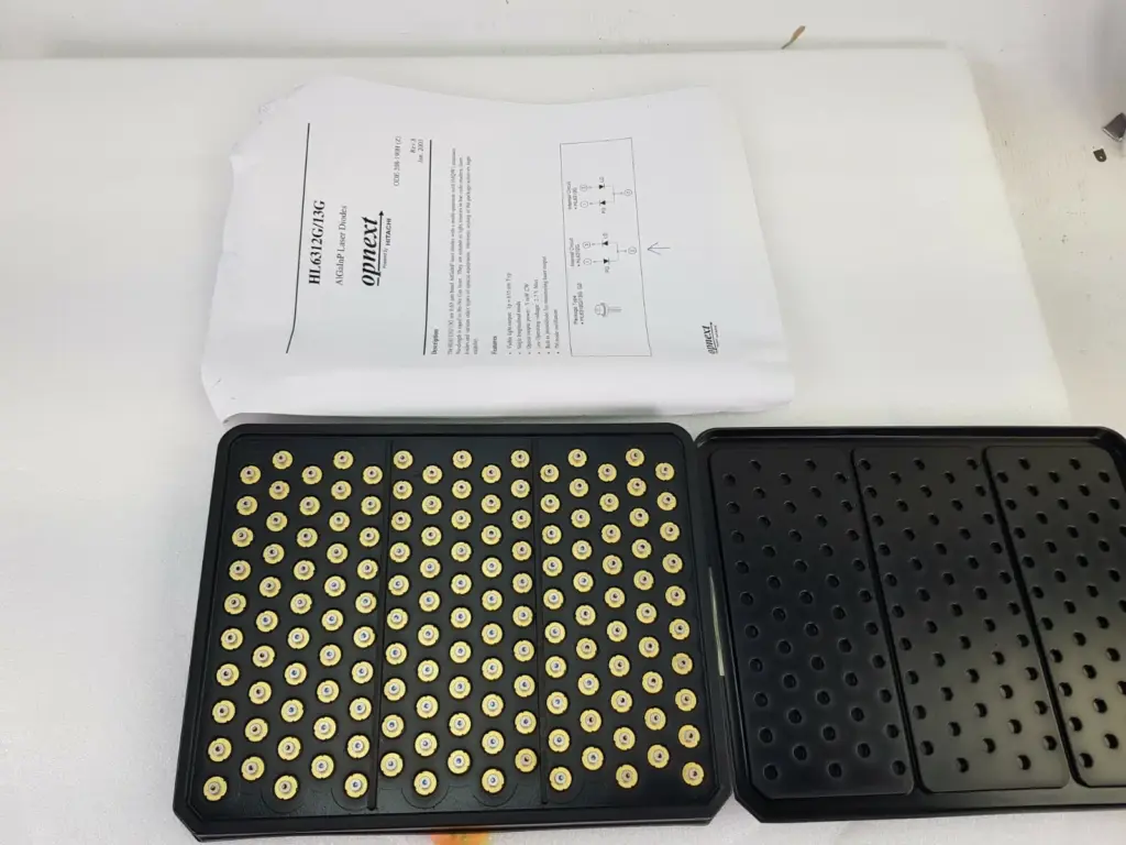 Tray of Hitachi / Opnext HL6312G laser diodes with the HL6312G/13G datasheet