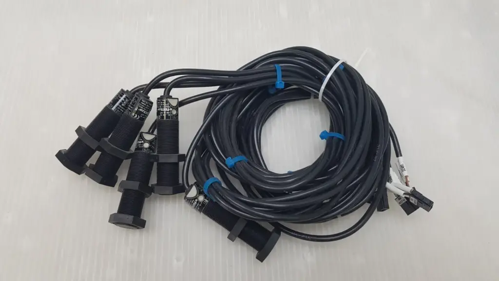 Five ifm efector KG5034 capacitive sensors, M18, with coiled black cables