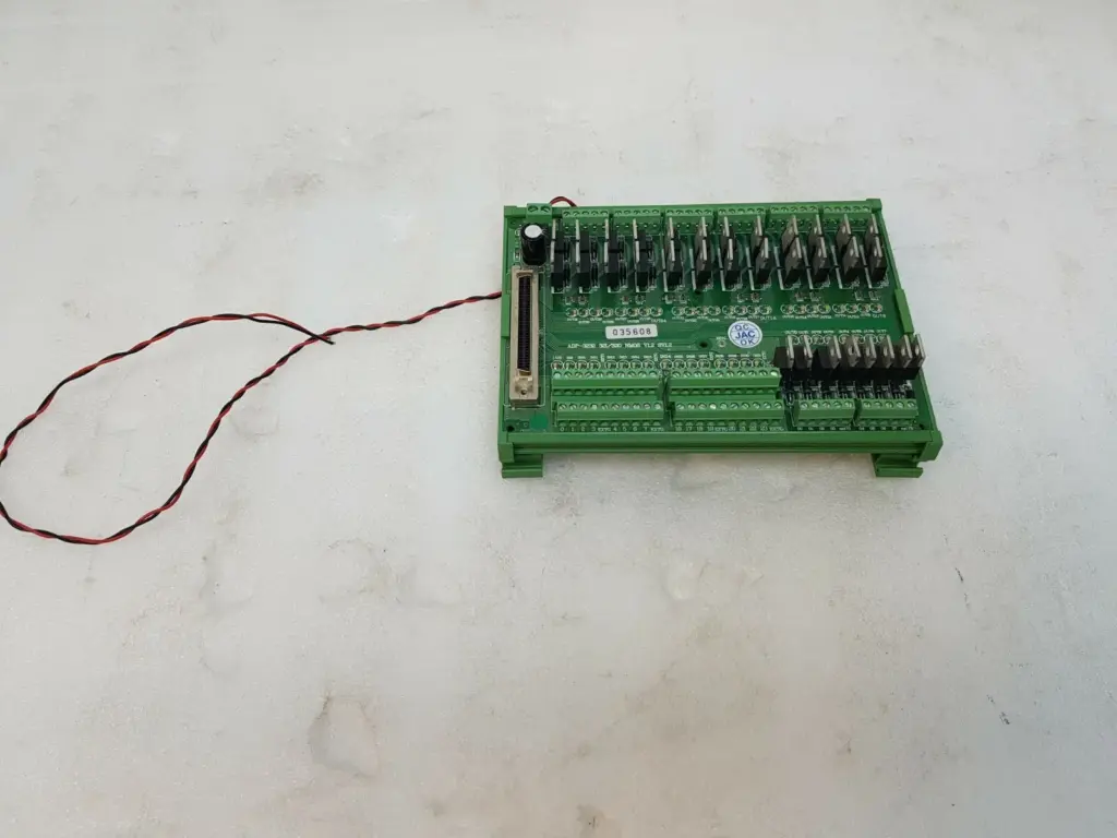 JS Automation ADP-3232 32I/32O NMOS wiring board on DIN rail carrier with red and black lead