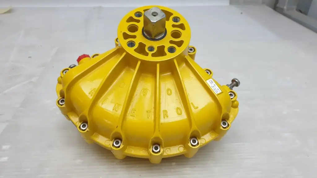 Kinetrol 091-100 Model 09 yellow rotary vane actuator, square drive and mounting flange on top, travel stop screws