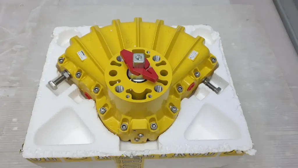 Yellow Kinetrol 123-100 Model 12 double acting actuator in its foam packaging, red position indicator