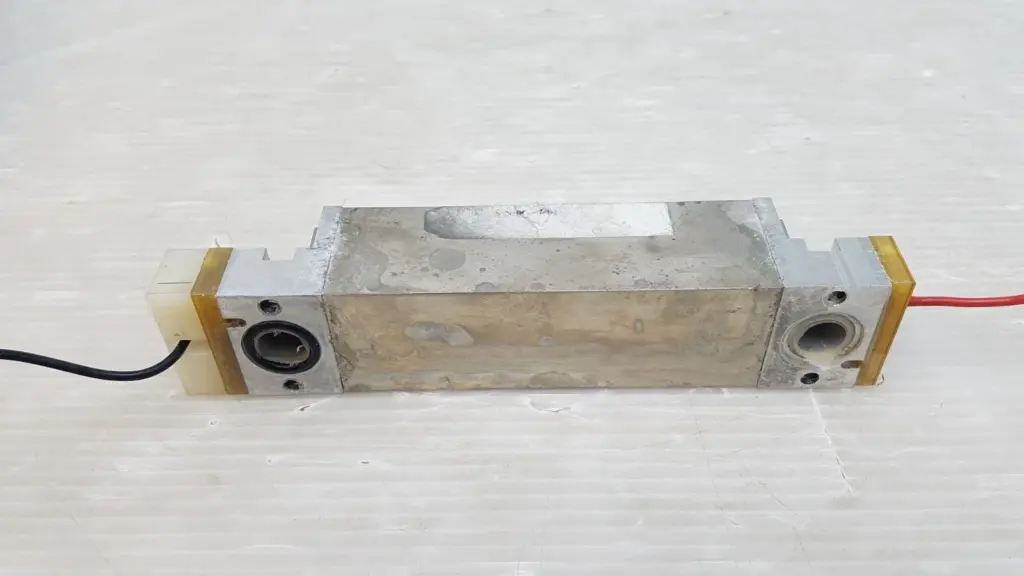 Lumenis laser long brick 0637-988-01, angled view showing the round openings in both end blocks