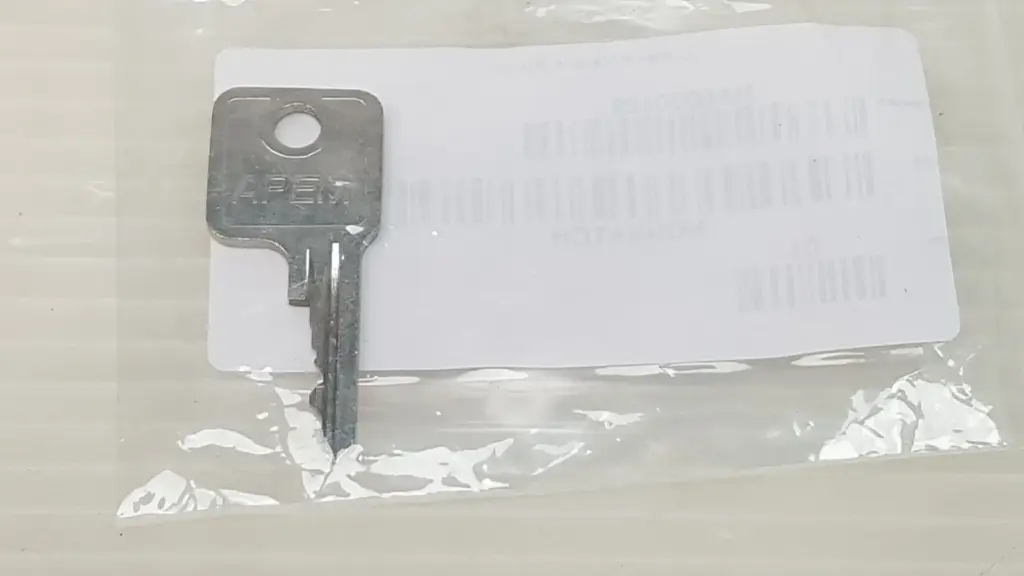 Lumenis HA0000129 spare key stamped APEM in its labeled Lumenis bag