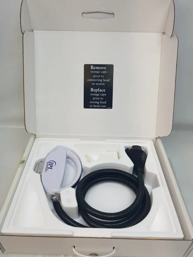 Lumenis IPL Quantum SR 590 treatment head and hose in its open head-case with instruction card