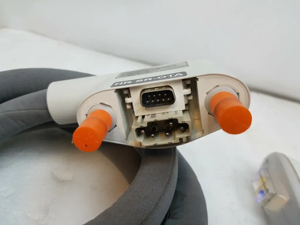 Connector end of the Lumenis HR SR-OTA head: 9-pin D-sub, 6-pin connector, capped coolant ports