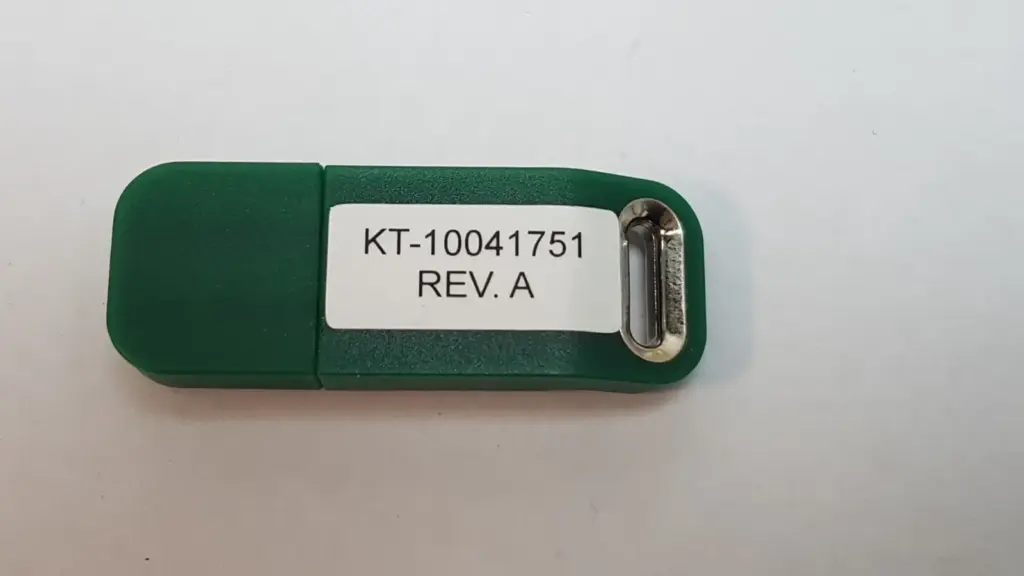 Green Lumenis plug labeled KT-10041751 Rev. A with metal key-ring eyelet