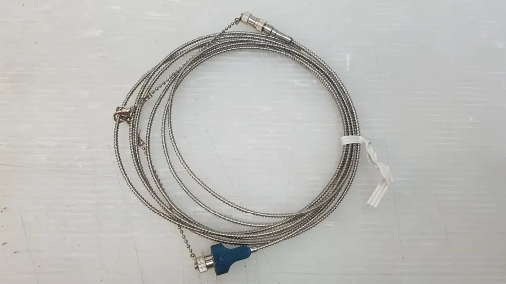 Coiled stainless steel armored fiber optic cable OP-10022430 with blue knurled connector grip