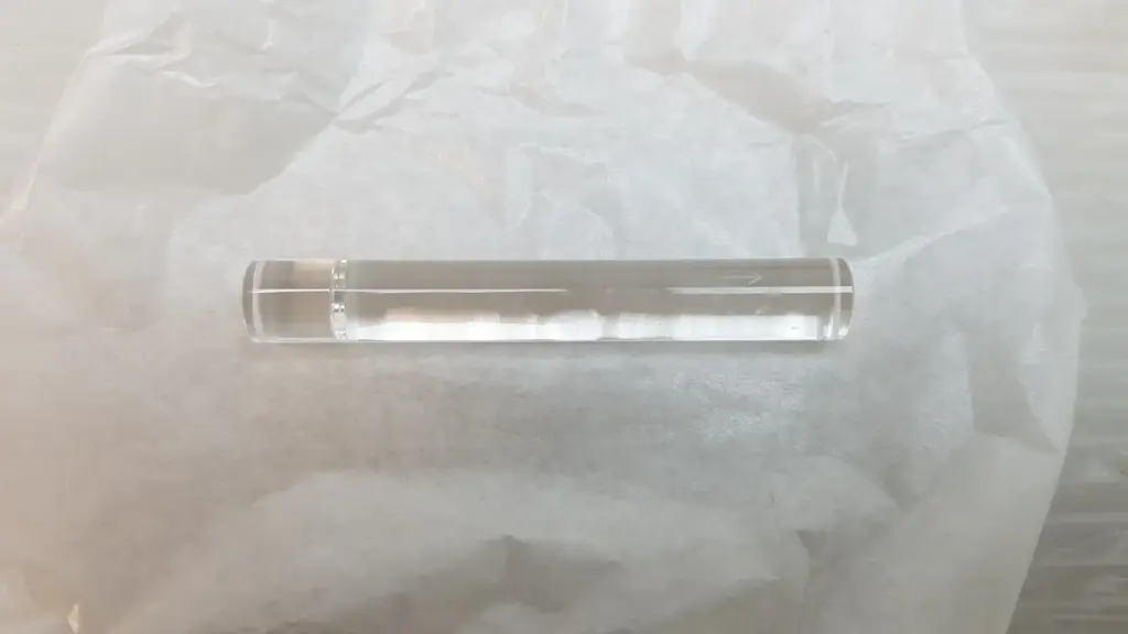 Lumenis OP2438040 clear glass light guide rod, 10 x 70 mm, on white paper