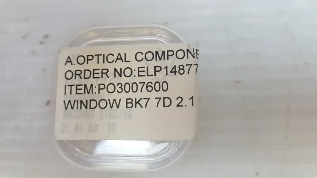 Clear case labeled A. Optical Components, item PO3007600, window BK7 7D 2.1