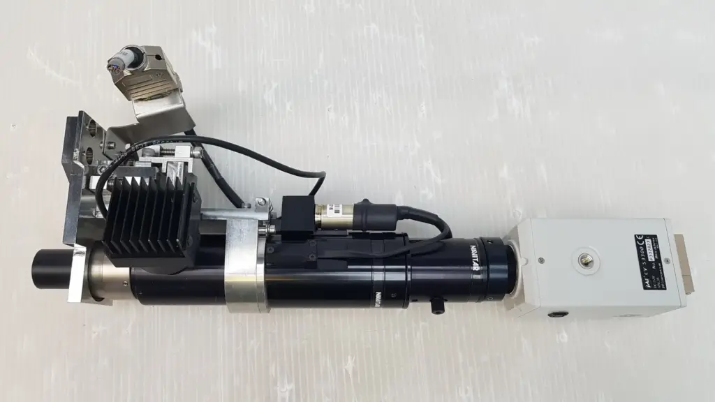Navitar motorized zoom lens assembly with JAI CV-S3300 camera on aluminum bracket, top view