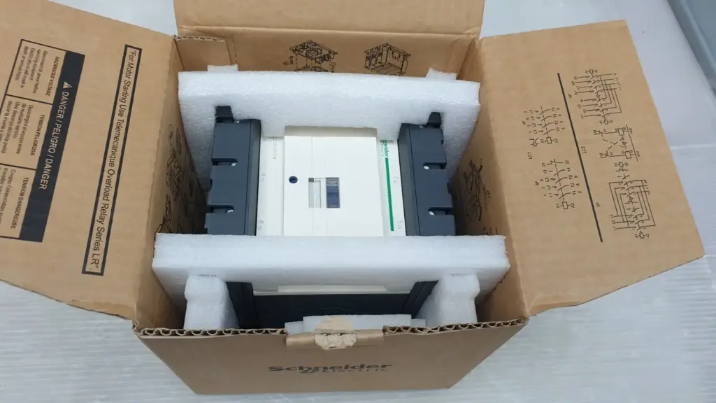 Schneider Electric LC1D115004P7 4-pole contactor in its open carton with foam inserts