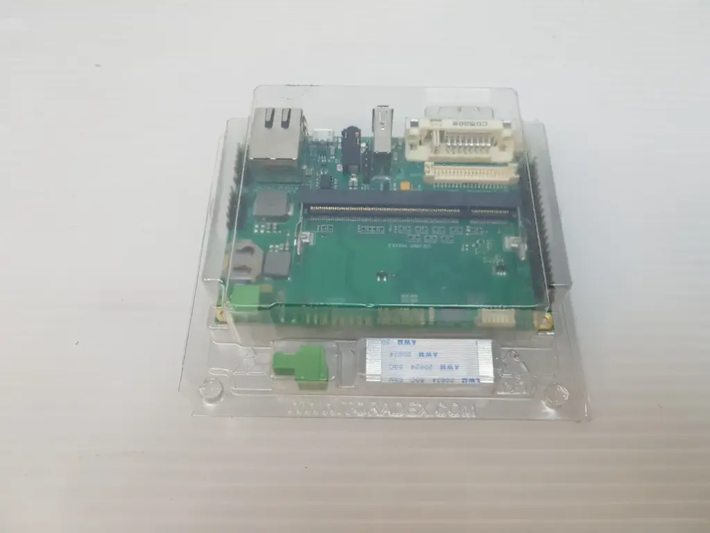 Toradex Iris V2.0A carrier board in its clear Toradex blister tray with power plug and flat cable
