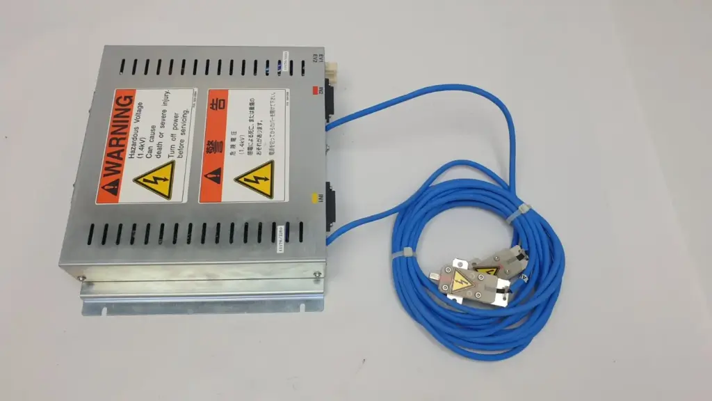 TREK high voltage assembly enclosure with 1.4kV warning labels and two blue output cables